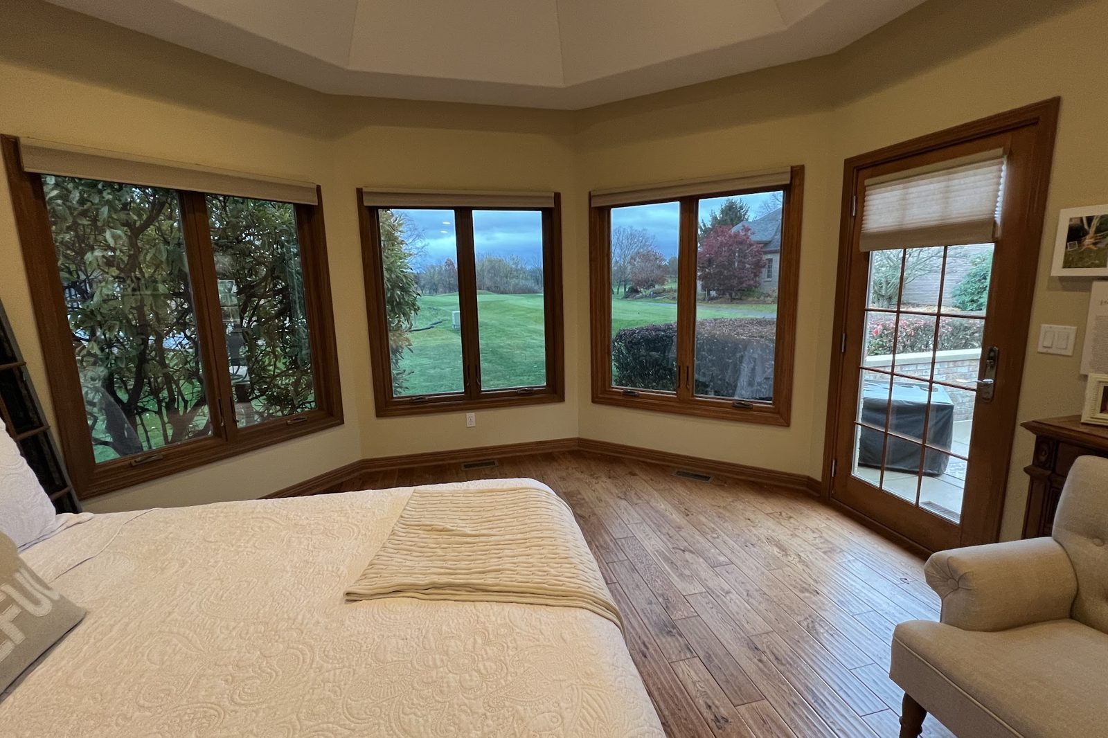 Bedroom bay windows with clear heat and glare control film overlooking a golf course